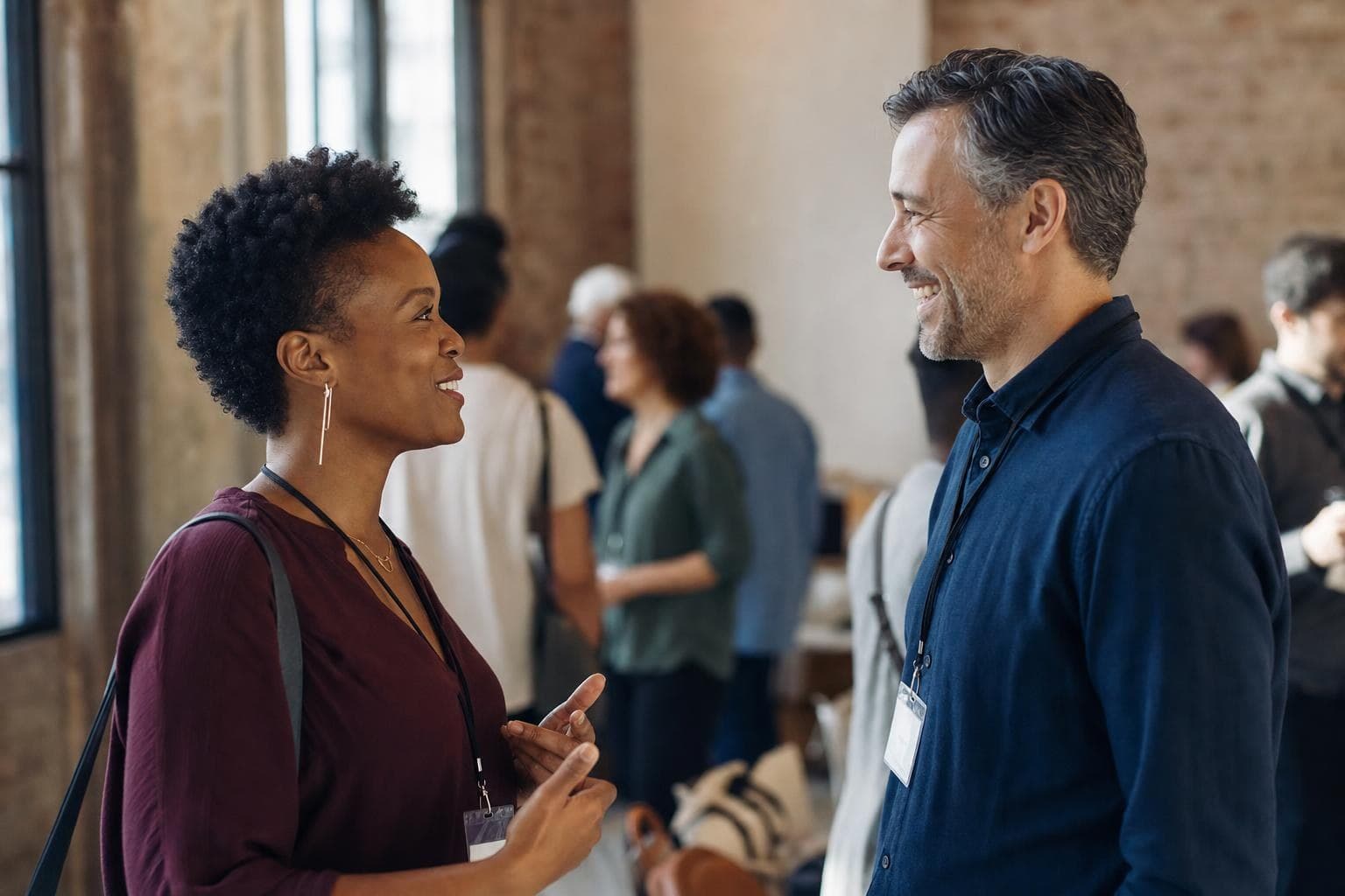 Two business people having a genuine, relaxed conversation at a local event.