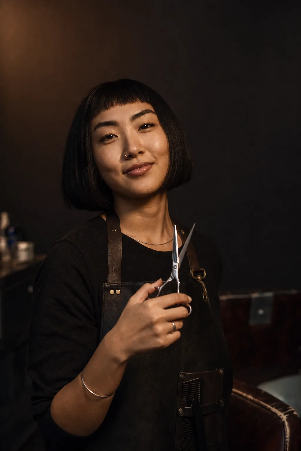 Rae Chen with poised scissors, blunt bob, quietly amused