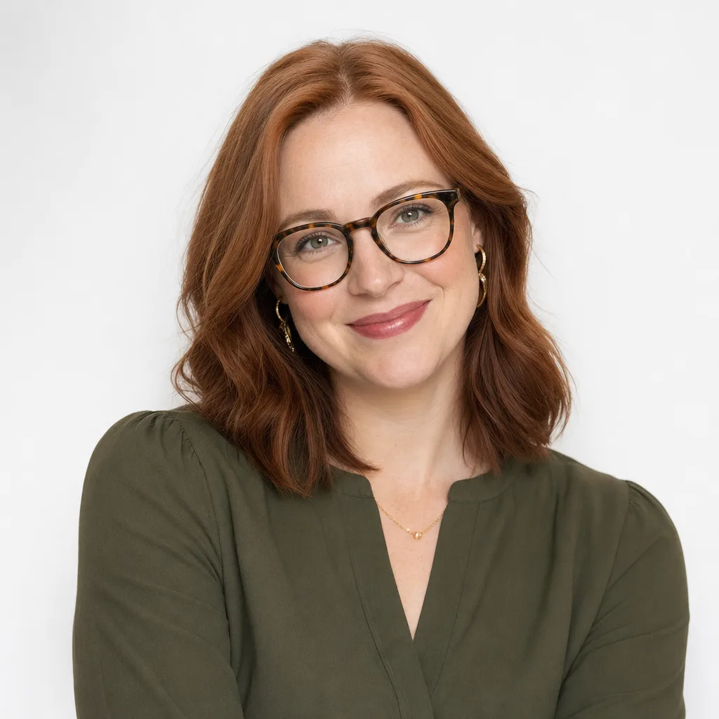 Portrait of a smiling strategist with red hair and glasses