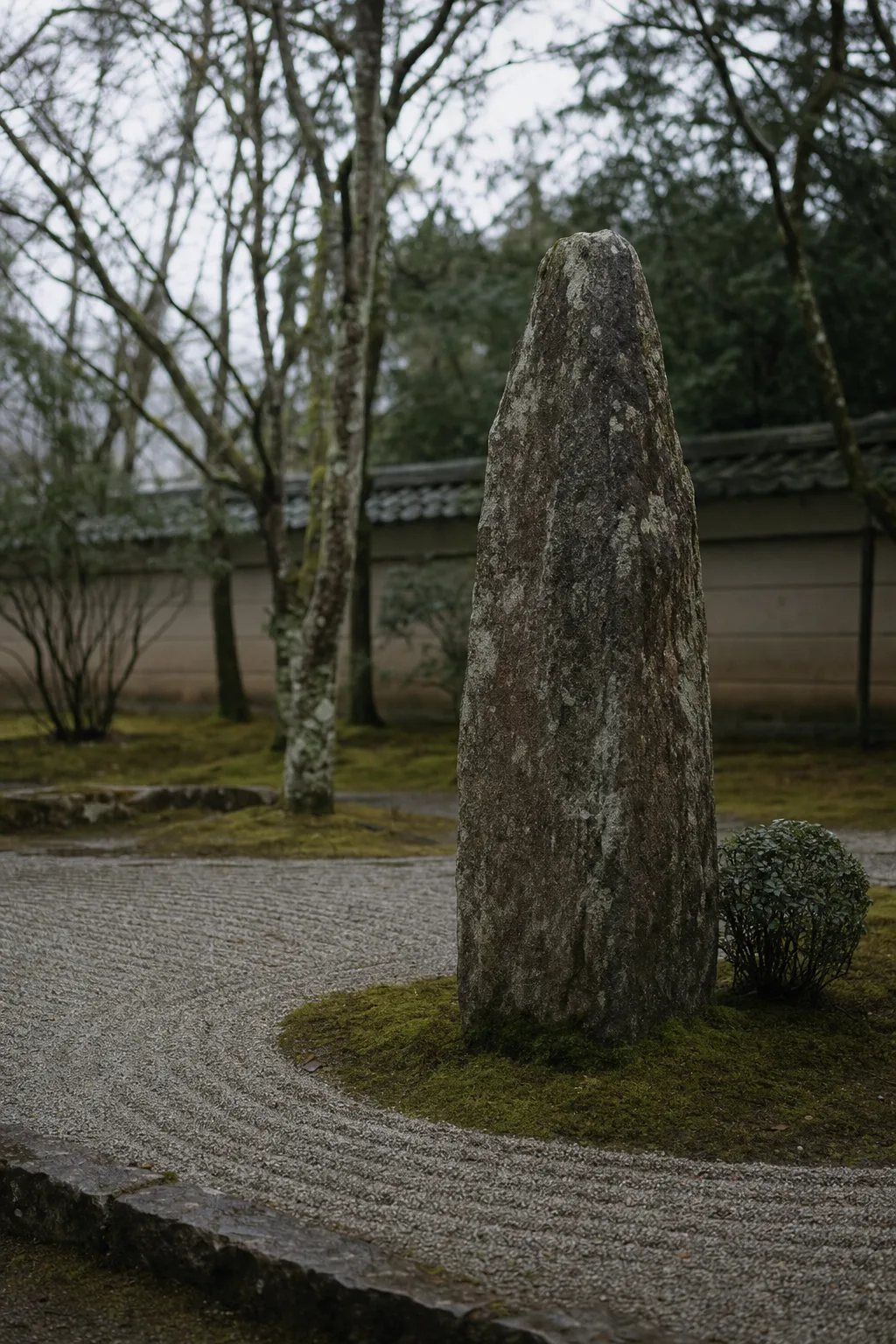 A standing stone in deep moss in the Baika garden