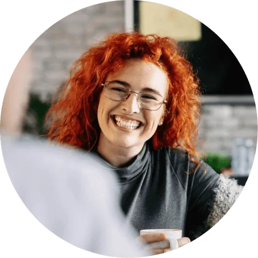 Team member with a coffee mug at her desk