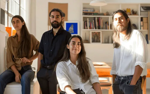 Team collaborating around a laptop in a casual office