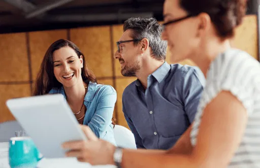 Business team smiling while discussing a project