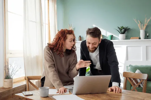 Two people reviewing analytics on a laptop