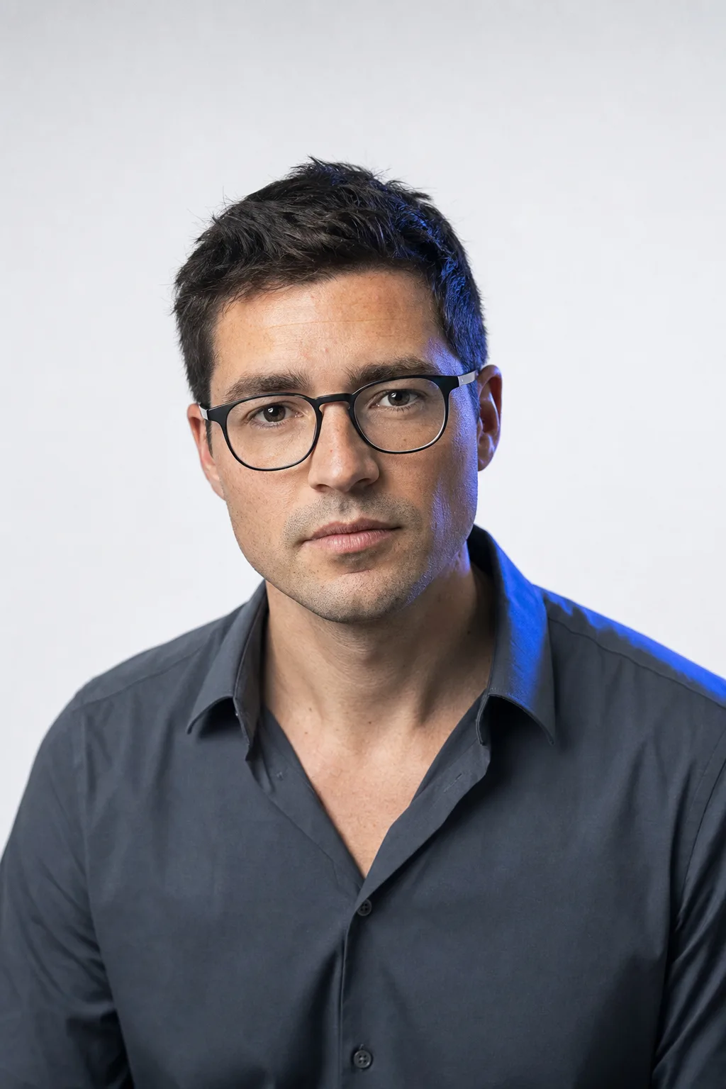 Portrait of a man in his thirties, direct gaze, neutral light.