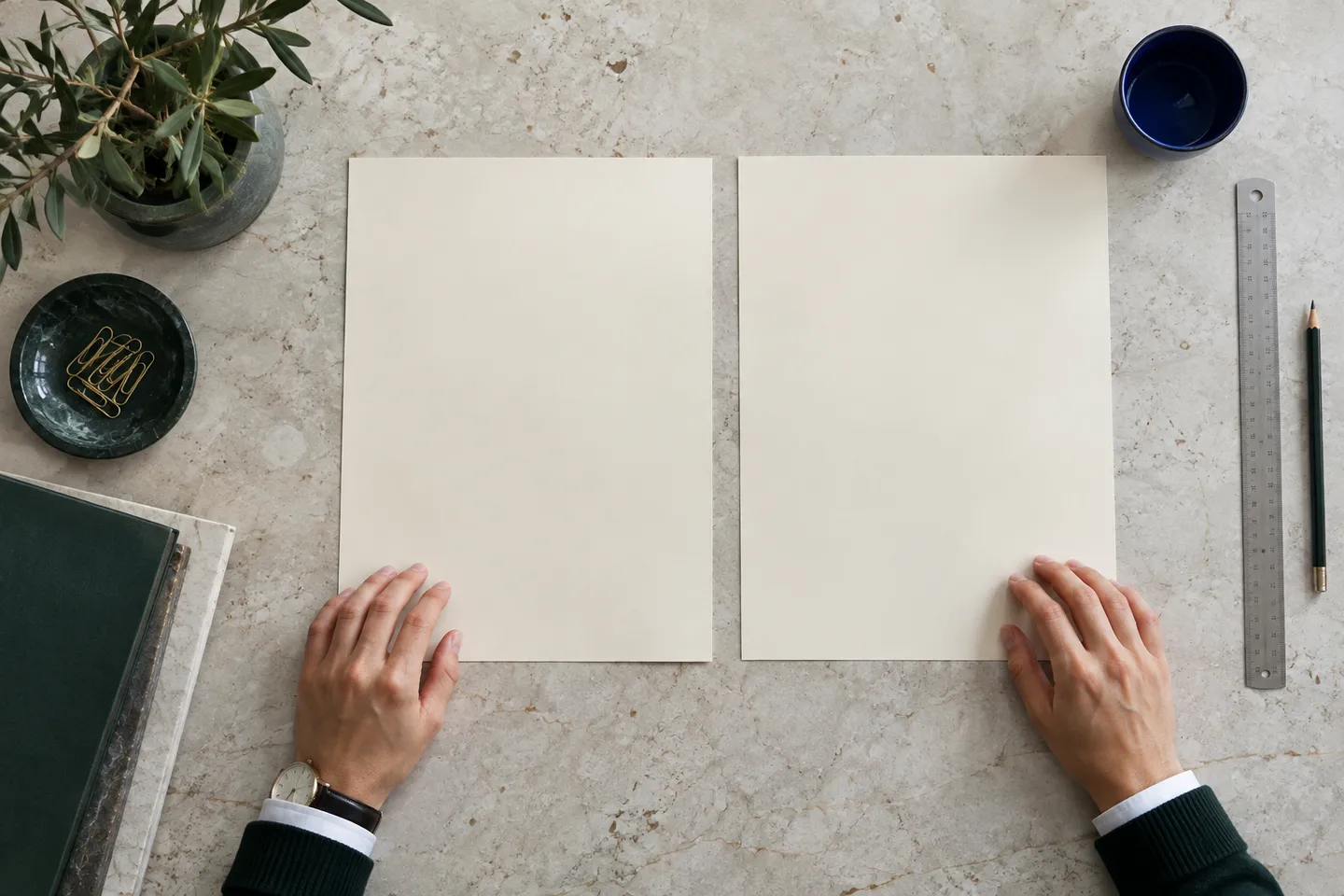 Two blank sheets and a pencil arranged on a light table